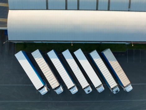 Aerial view of goods warehouses and logistics center in industrial city zone from above.